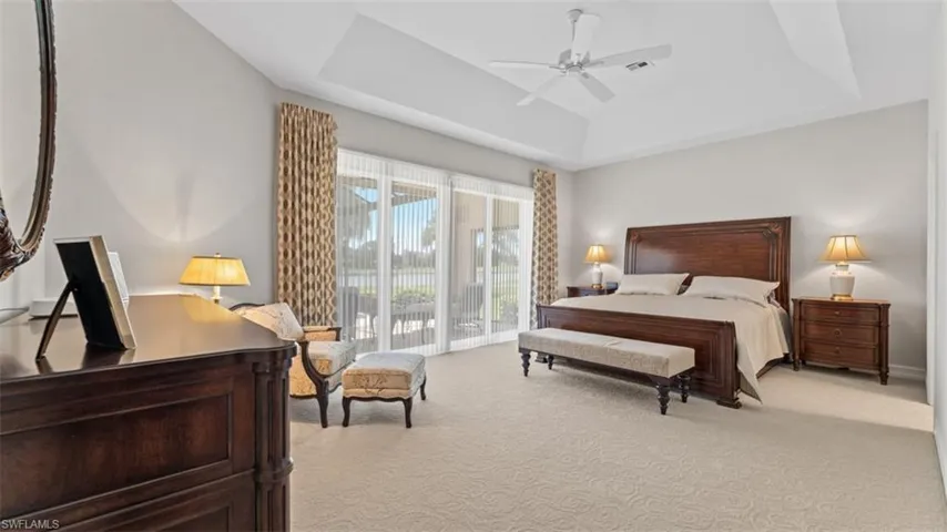 Spacious room featuring a tray ceiling, recessed lighting, and a ceiling fan