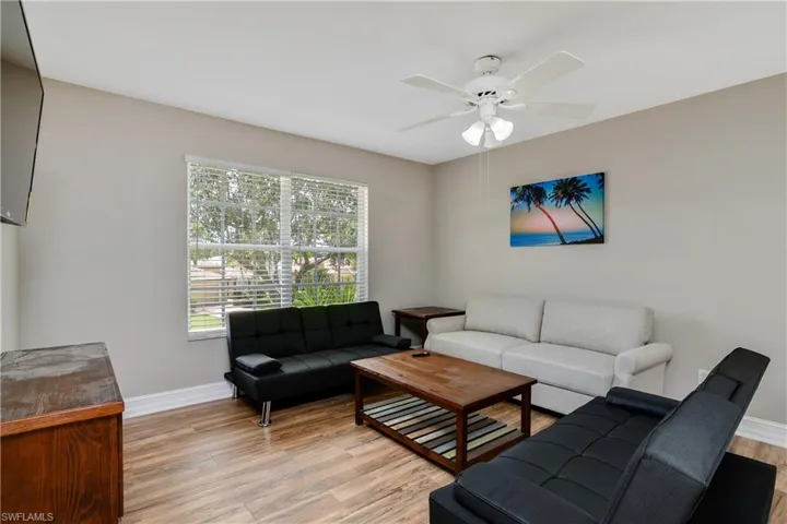 Living room featuring ceiling fan and hardwood / wood-style flooring