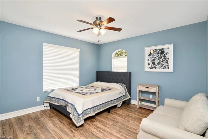 Bedroom featuring wood-type flooring and ceiling fan