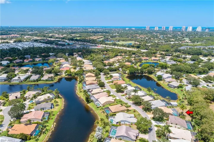 Birds eye view of property with a water view