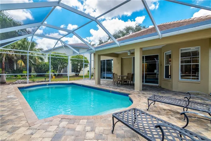 View of pool with ceiling fan, a lanai, and a patio area