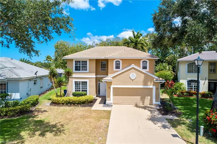 Front of property with a front lawn and a garage