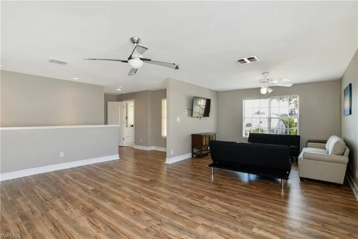 Living room with hardwood / wood-style flooring and ceiling fan