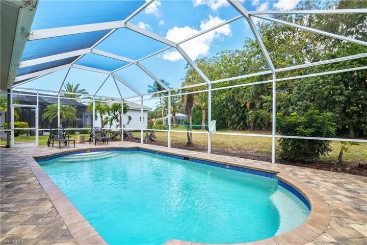 View of pool with a patio and a lanai