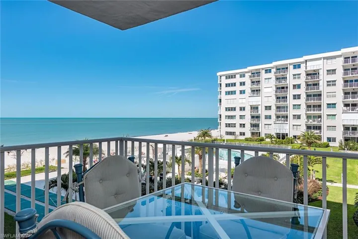 Balcony with view of water and beach