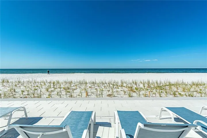 View of patio / terrace featuring view of water and beach