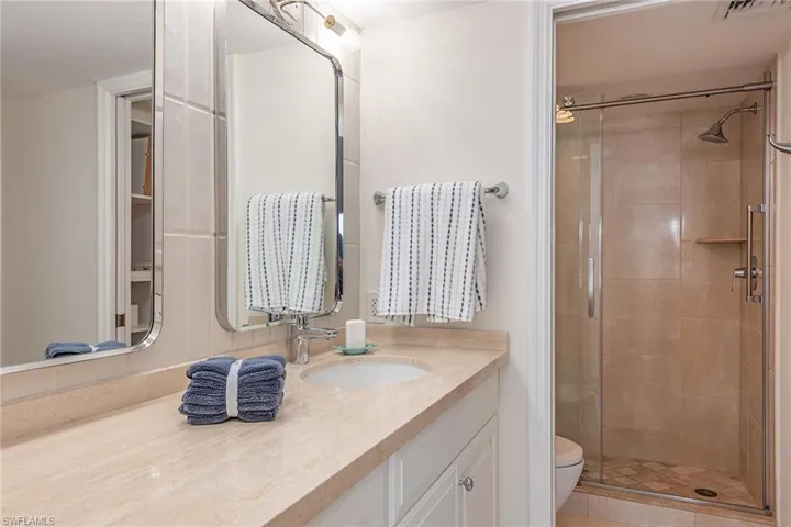 Full bath featuring a shower stall and vanity