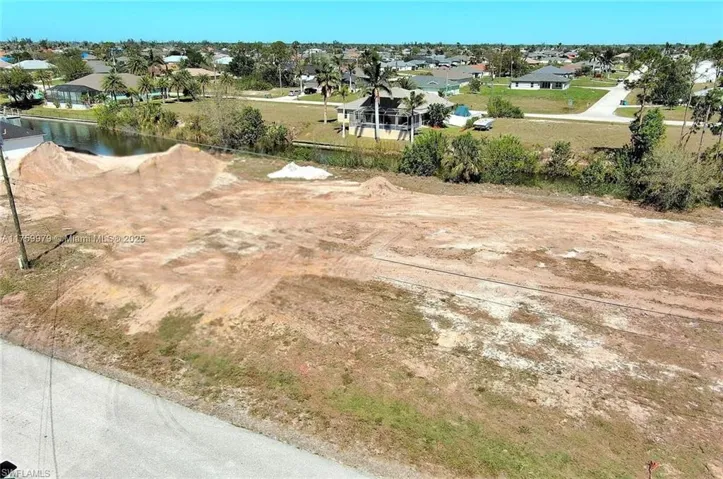 Aerial view of residential area featuring a nearby body of water