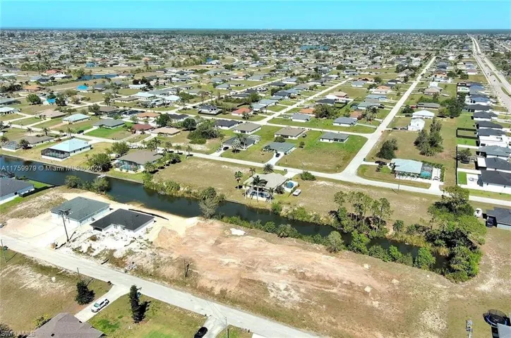 Aerial overview of property's location with nearby suburban area and a large body of water