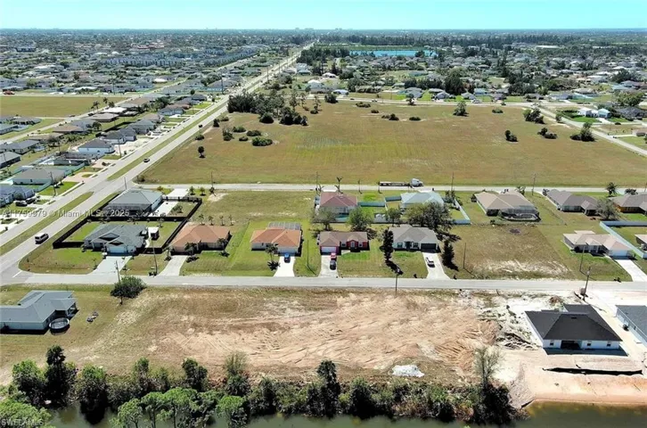 Aerial perspective of suburban area featuring a large body of water