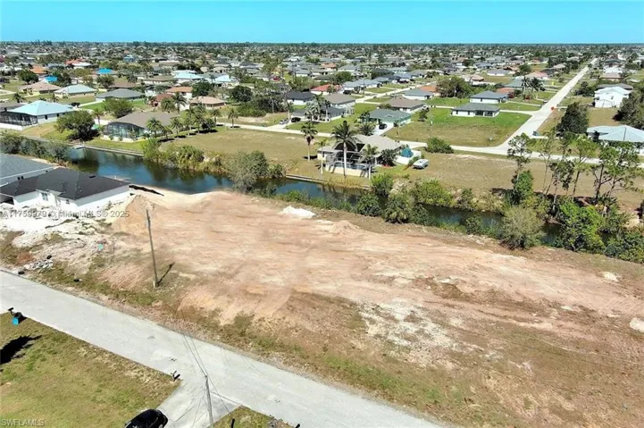 View of property location with a large body of water and nearby suburban area