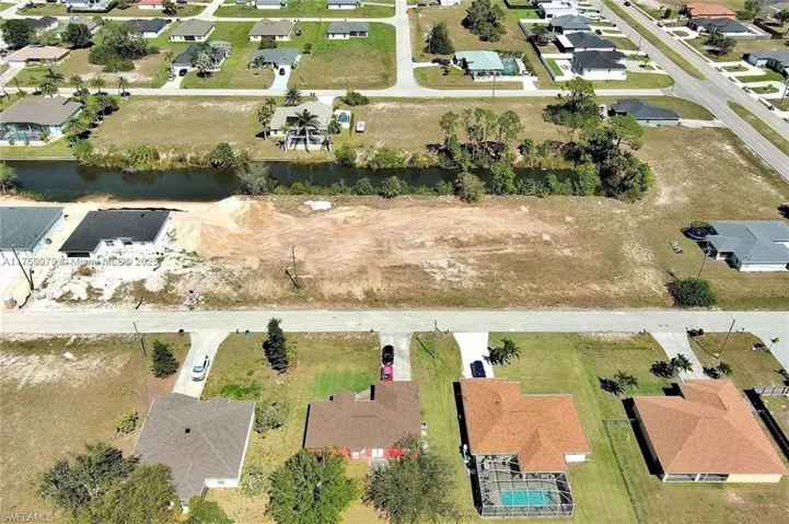 Aerial overview of property's location featuring nearby suburban area and a nearby body of water