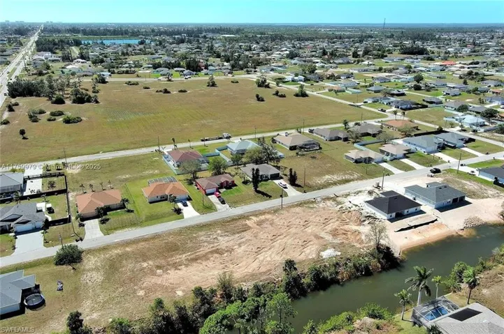 Aerial view of residential area featuring a large body of water