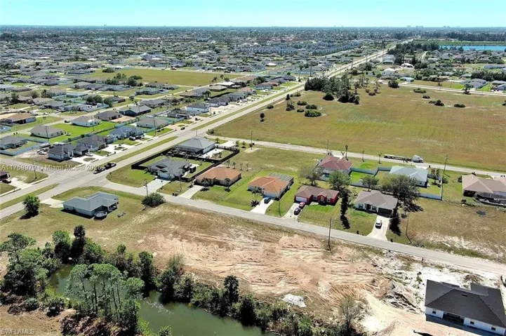 Aerial overview of property's location with a nearby body of water and nearby suburban area