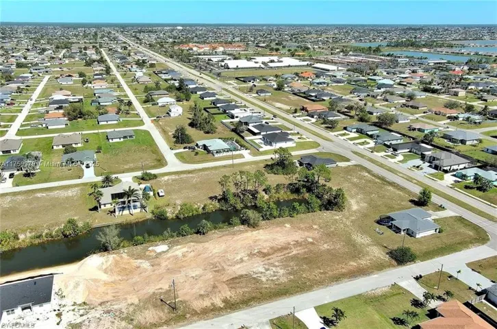 View of property location with a large body of water and nearby suburban area