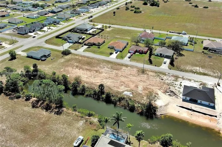 Aerial overview of property's location with a large body of water and nearby suburban area
