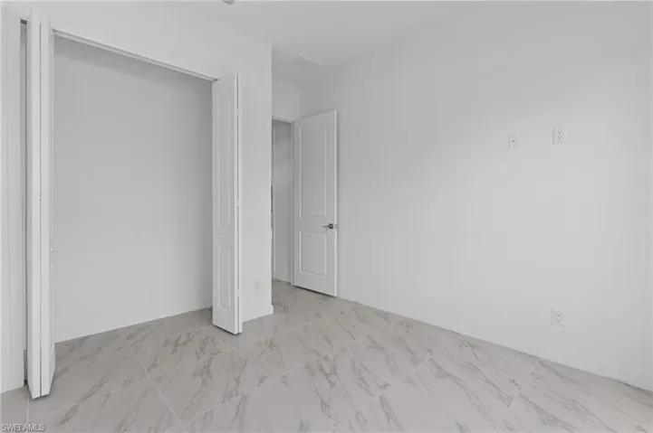 Unfurnished bedroom with baseboards and a closet