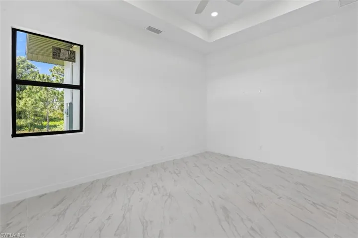 Spare room featuring recessed lighting, ceiling fan, and light marble finish flooring