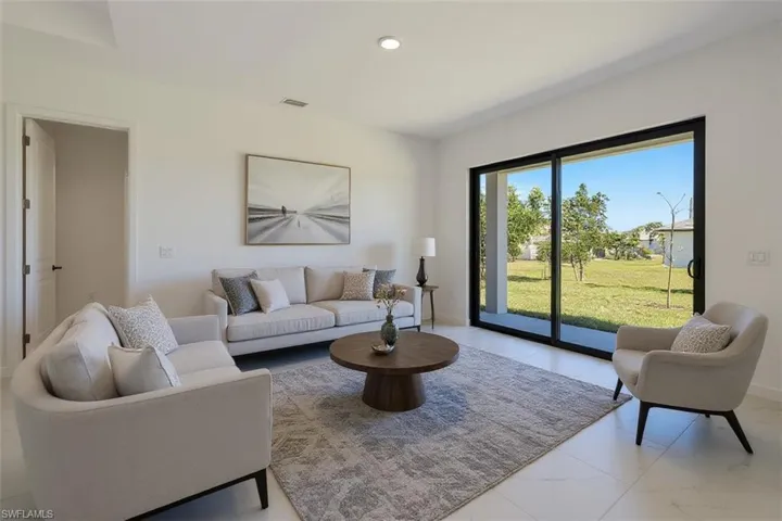 Living area featuring baseboards and recessed lighting