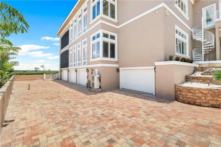 View of garage entry on the left side of the house.  Garage doors are also on the right side of the house