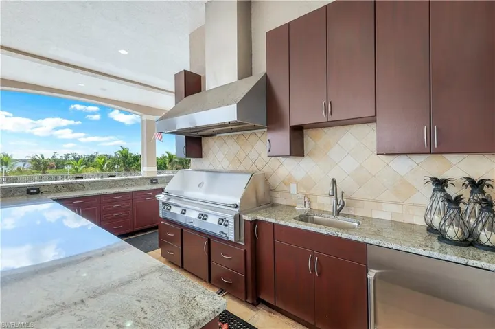 View of patio / terrace with exterior kitchen featuring a natural gas grill and plenty of cabinetry