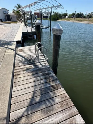 Dock area featuring a water view and boat lift