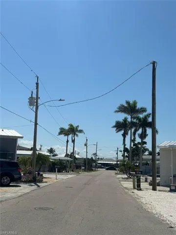 View of asphalt road with street lights