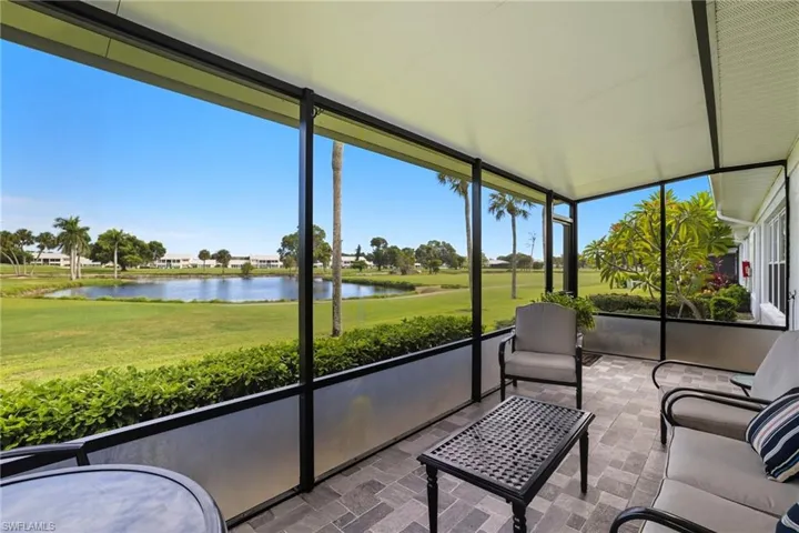 Sunroom / solarium with a water view