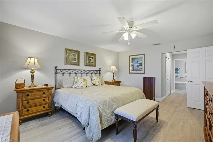 Bedroom with light wood finished floors, a closet, and a ceiling fan