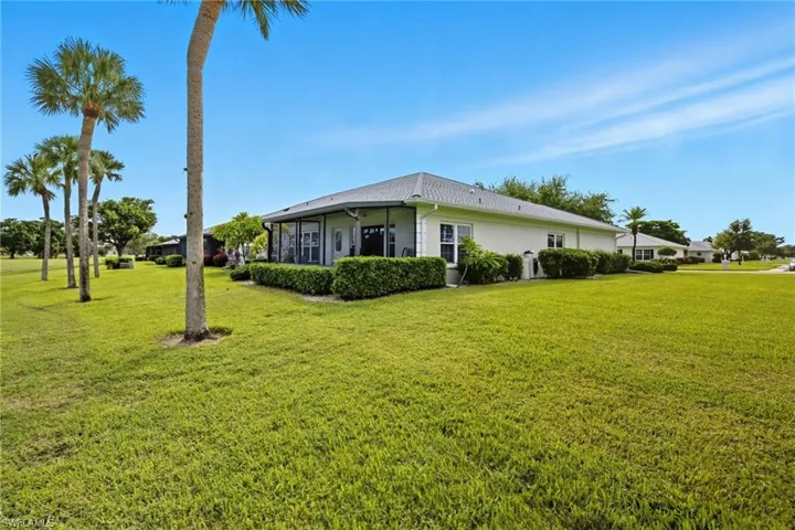 View of property exterior with a yard
