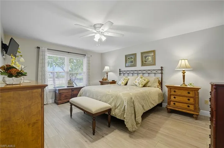 Bedroom with light wood-style floors and ceiling fan