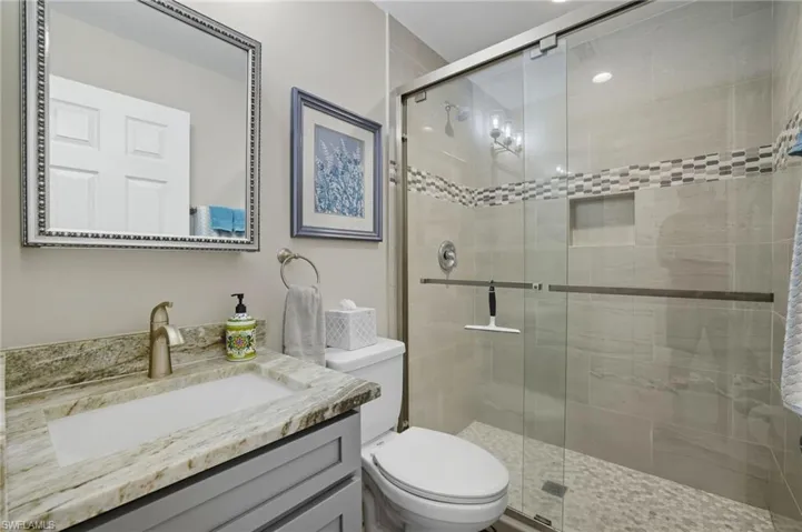 Bathroom featuring vanity and a shower stall