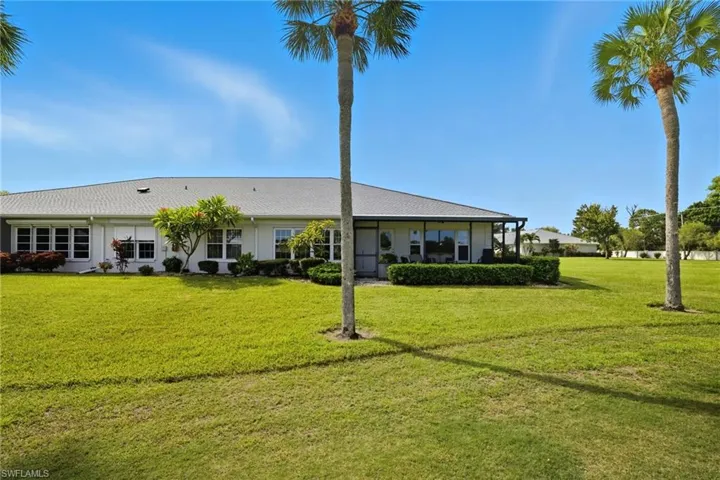 Rear view of property featuring a lawn
