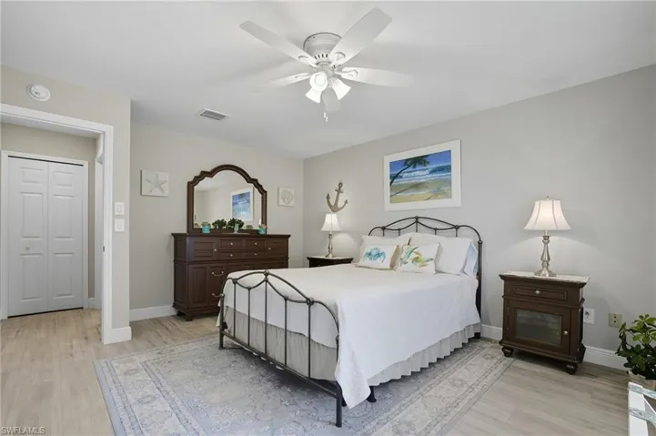 Bedroom with light wood finished floors and a ceiling fan