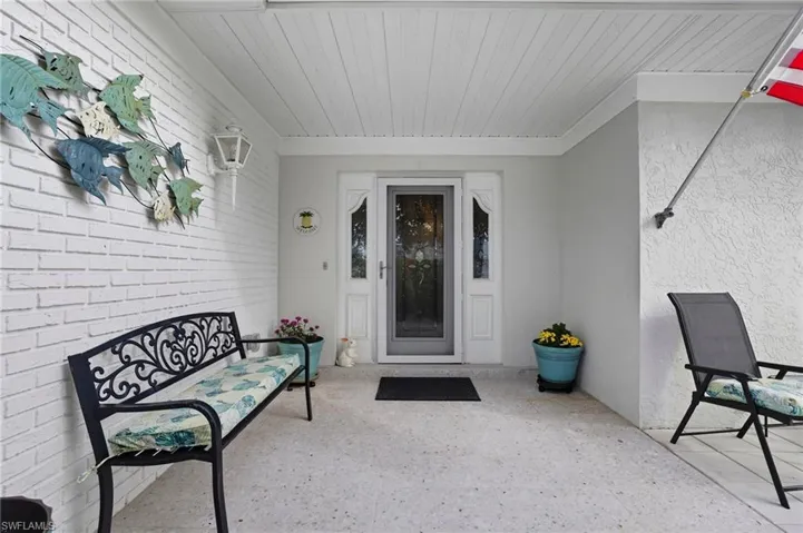 Entrance to property featuring stucco siding and a patio area