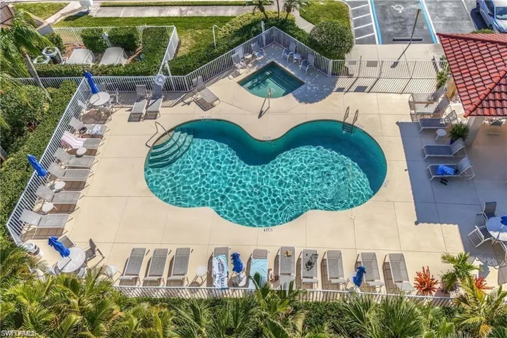 View of swimming pool featuring a patio and a community hot tub
