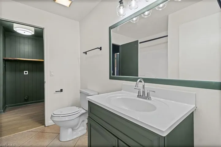 Full bathroom with vanity and light tile patterned flooring