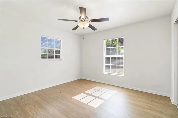Spare room featuring light wood-type flooring and ceiling fan