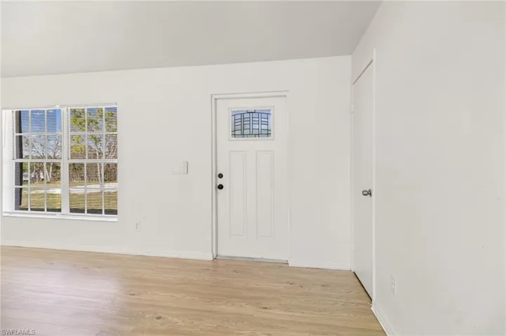 Entrance foyer featuring light wood-style floors and baseboards