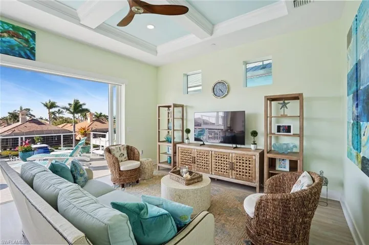 Living room with a healthy amount of sunlight, and coffered ceiling