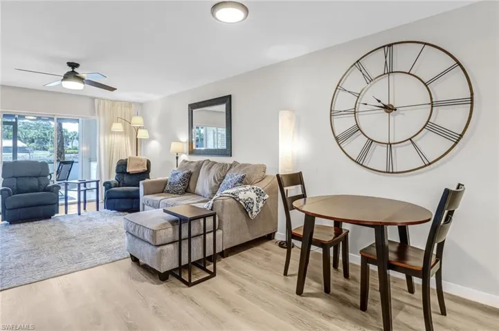 Living room featuring ceiling fan and light hardwood / wood-style flooring