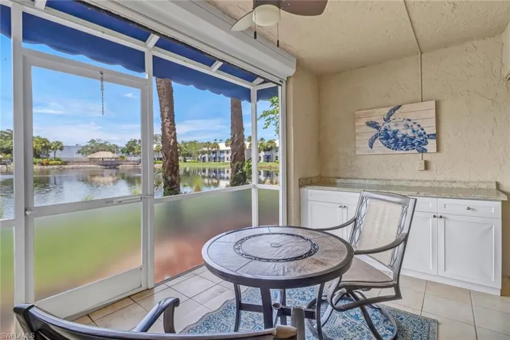 Lanai featuring ceiling fan and a water view