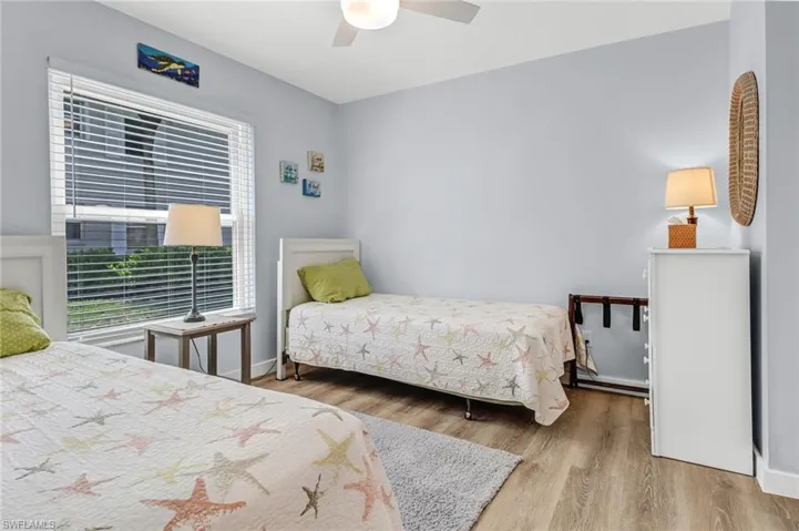 Bedroom featuring ceiling fan and hardwood / wood-style floors