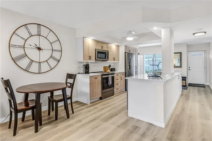 Kitchen featuring a center island, light hardwood / wood-style floors, light brown cabinetry, and stainless steel appliances