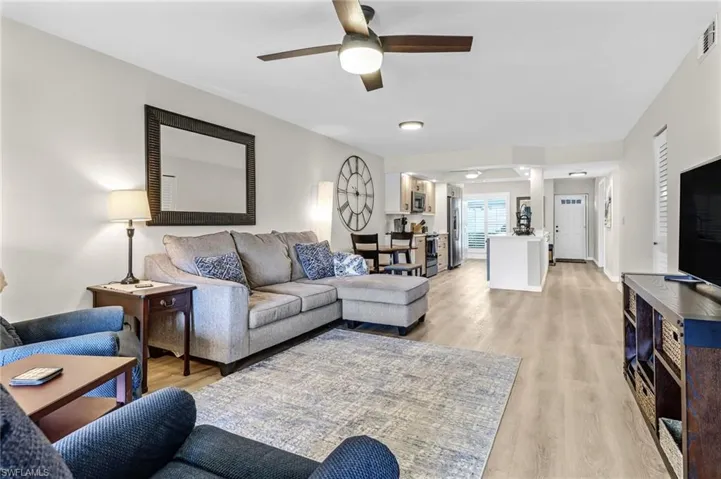 Living room featuring ceiling fan and light hardwood / wood-style floors