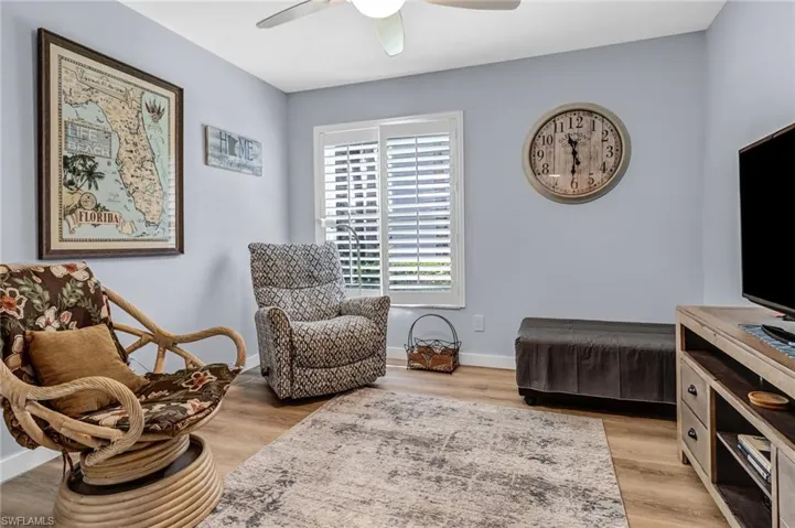 Living area with light wood-type flooring and ceiling fan