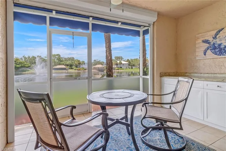 Tiled Lanai featuring a healthy amount of sunlight and a water view