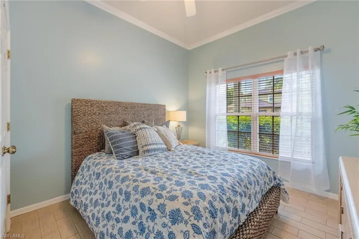 Bedroom 2 located at the front of the home. Notice the tile floor and crown molding throughout.