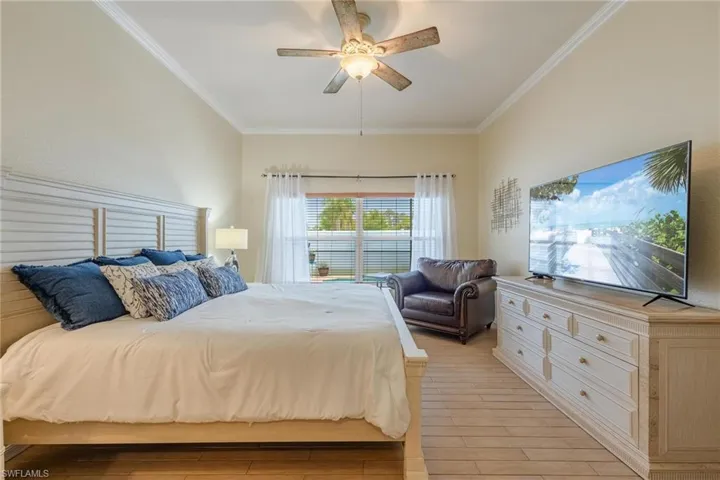 Primary Bedroom. Has 2 walk - in closets and views of the pool.