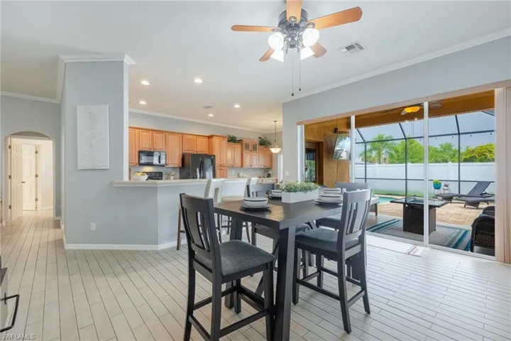 Another view of dining, kitchen, lanai and pool.